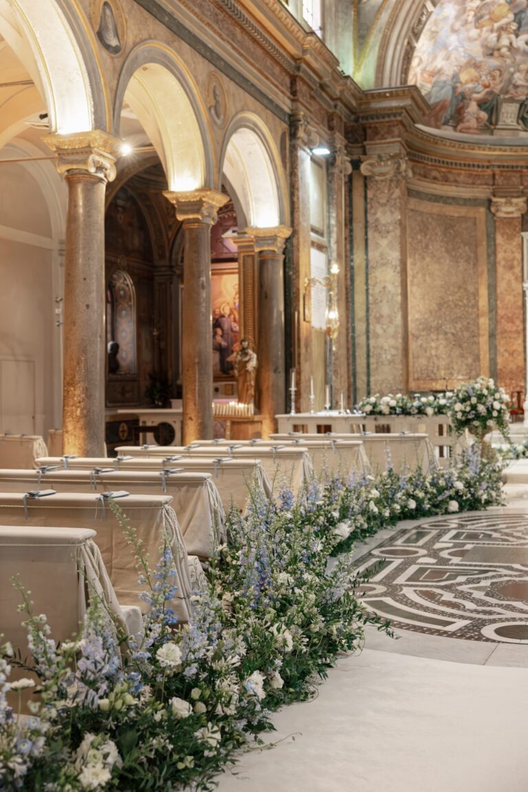 A floral runner lines the aisle beneath the colonnade, Maria Luisa Rocchi Flowers