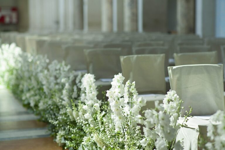 A bouquet of white rose and stock, the church aisle beyond, Villa Aurelia, Maria Luisa Rocchi Flowers