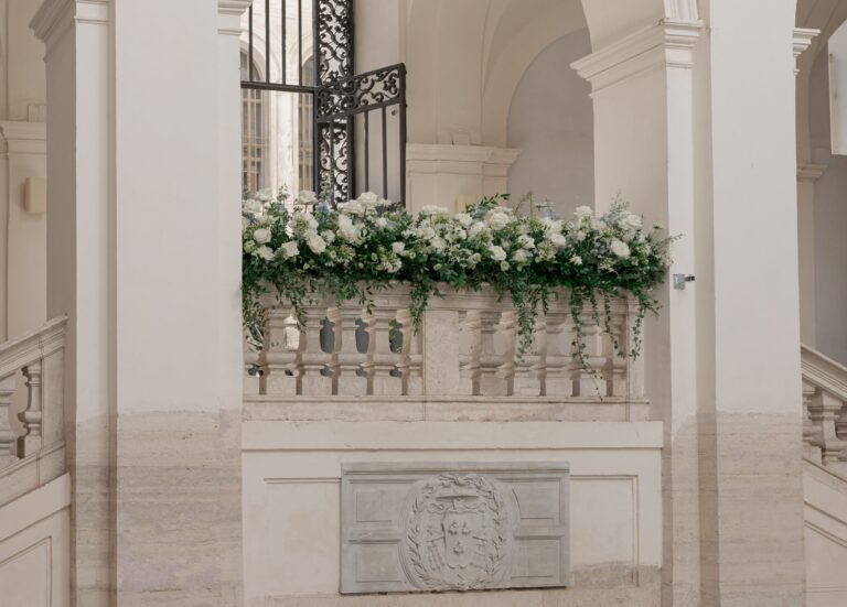A floral garland dresses a wrought-iron balcony gate, Maria Luisa Rocchi Flowers