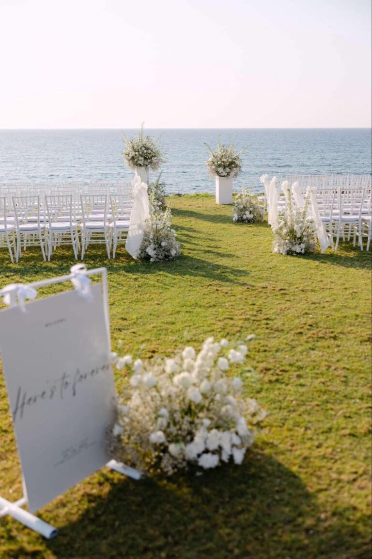 Ceremony welcome sign and floral pillars above the sea at Alassos, Paphos, Marry Me Cyprus