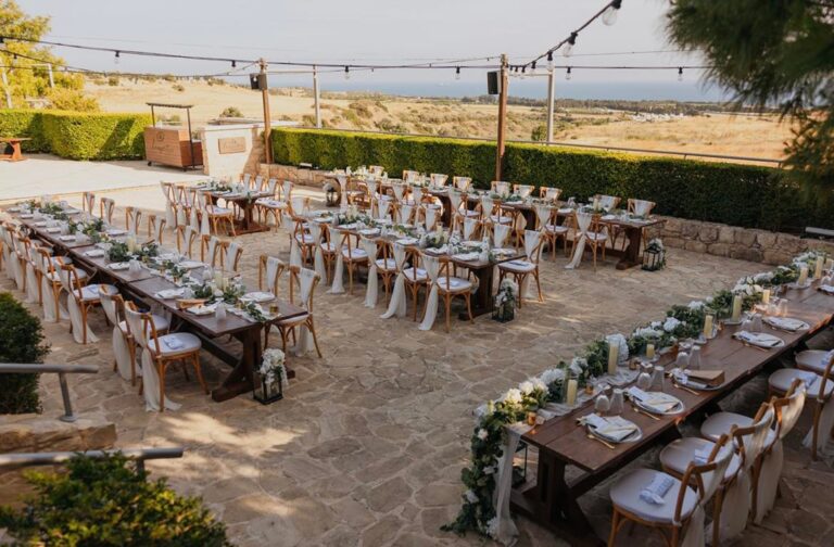Reception tables and festoon lights overlooking the sea at Liopetro, Kouklia, Marry Me Cyprus