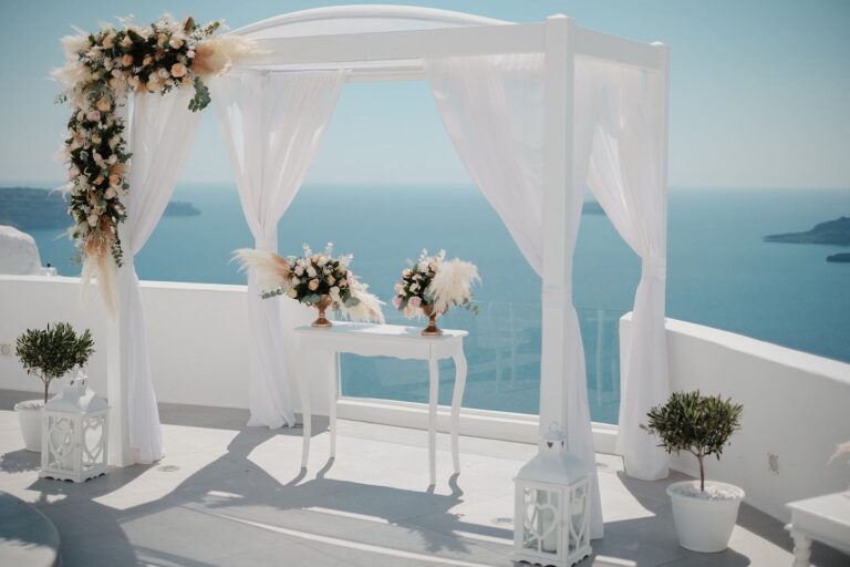 White ceremony canopy with flowers above the sea, Marryme in Greece