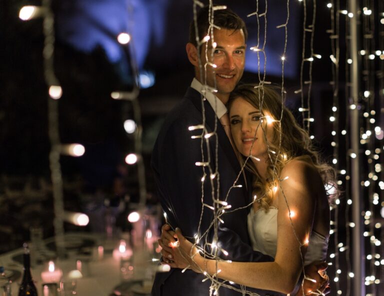 Couple at night among strings of fairy lights, Marryme in Greece