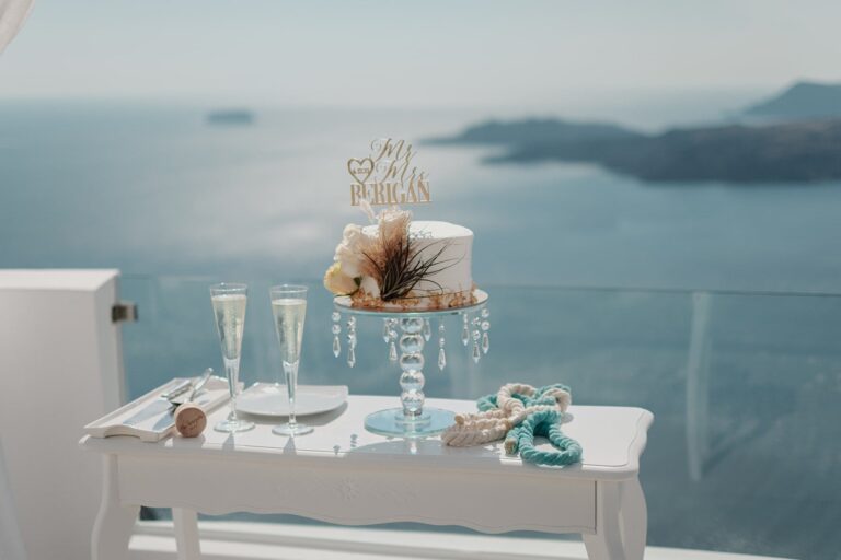 Cake and champagne on a white table above the sea, Marryme in Greece