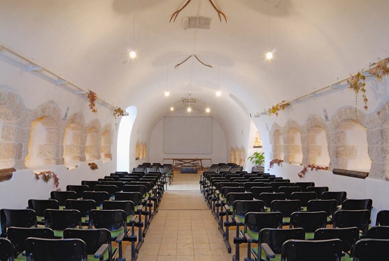 A vaulted room set with chairs for a ceremony, Masseria Spina Resort