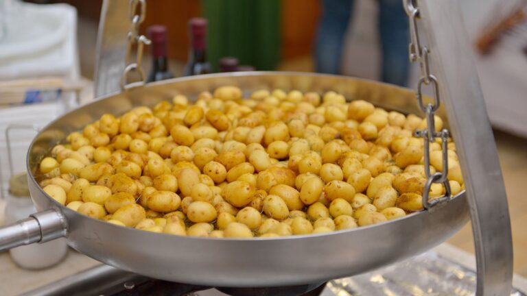 A pan of cooked chickpeas at a food station, Masseria Spina Resort