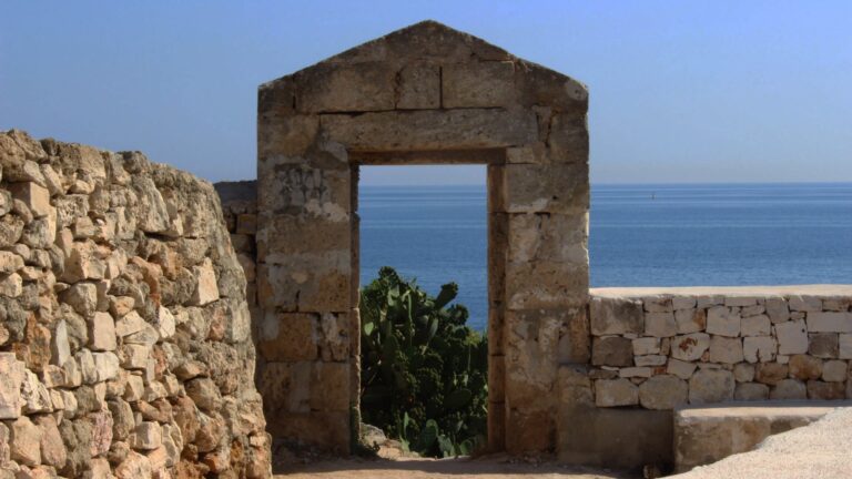 A stone gateway framing the sea, Masseria Spina Resort