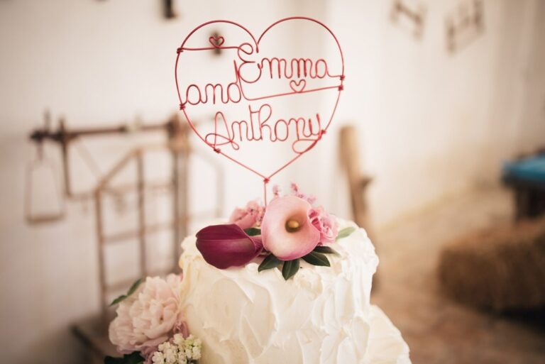 A wedding cake with a wire heart topper, Masseria Spina Resort