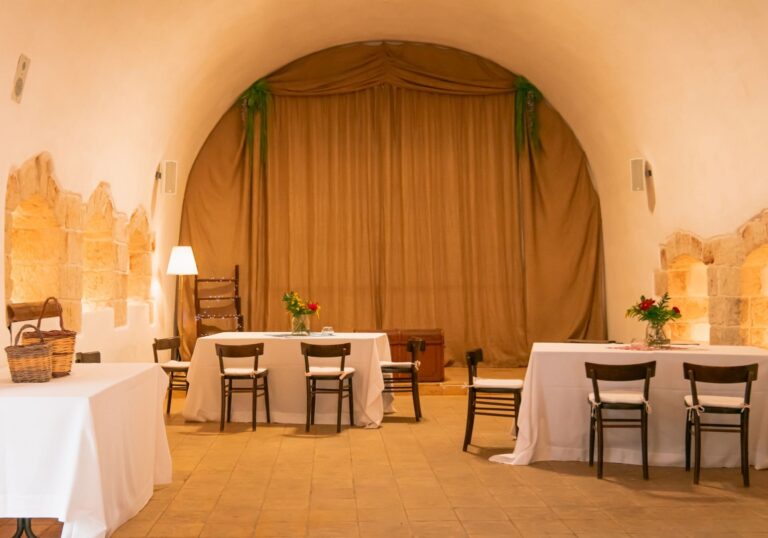 The Sala delle Mangiatoie, a vaulted hall used as a winery and event space, Masseria Spina Resort