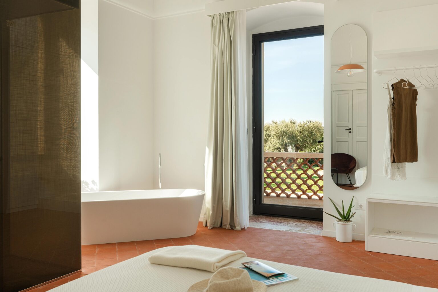 The Glicine Suite bedroom with a freestanding bath