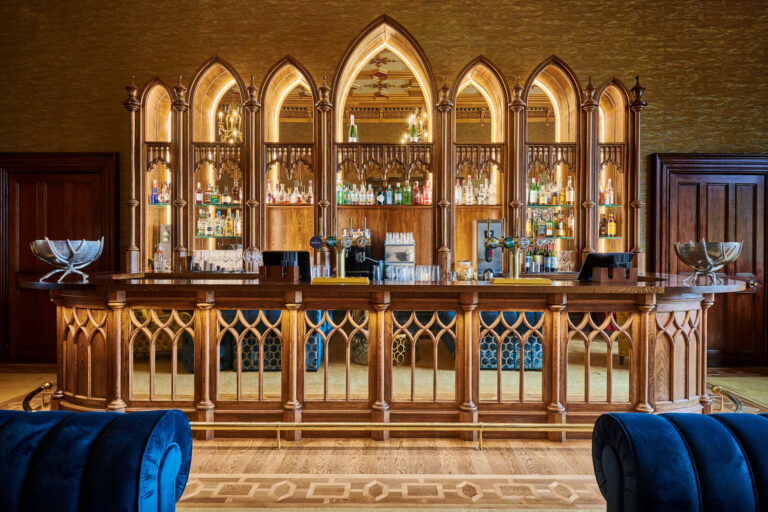 The 1832 bar, with its Gothic-arched oak back bar and blue velvet seating, Matfen Hall