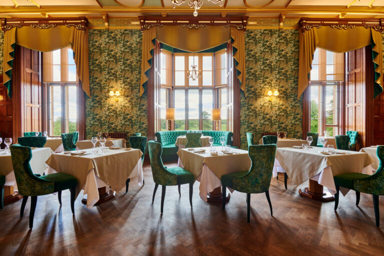 The Emerald Restaurant, with green velvet chairs, bay windows and patterned wallpaper, Matfen Hall