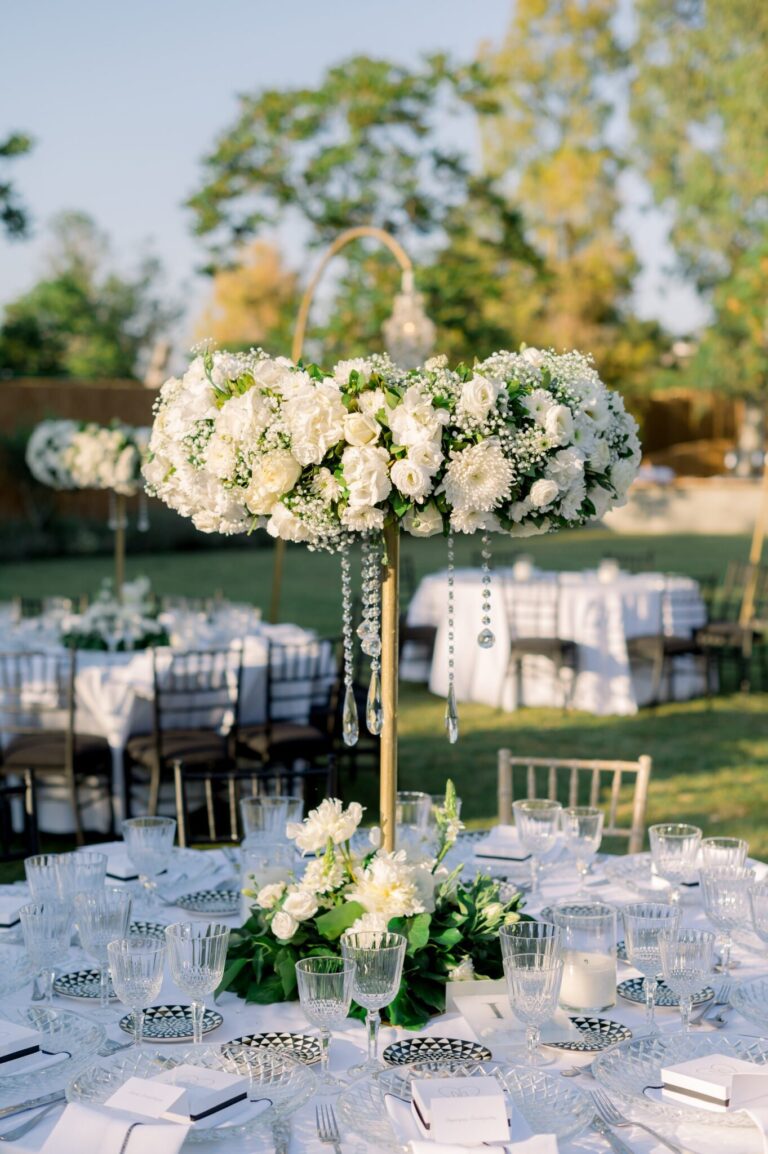 Tall white centrepiece over a laid dinner table, Mathioudakis Exclusive Events