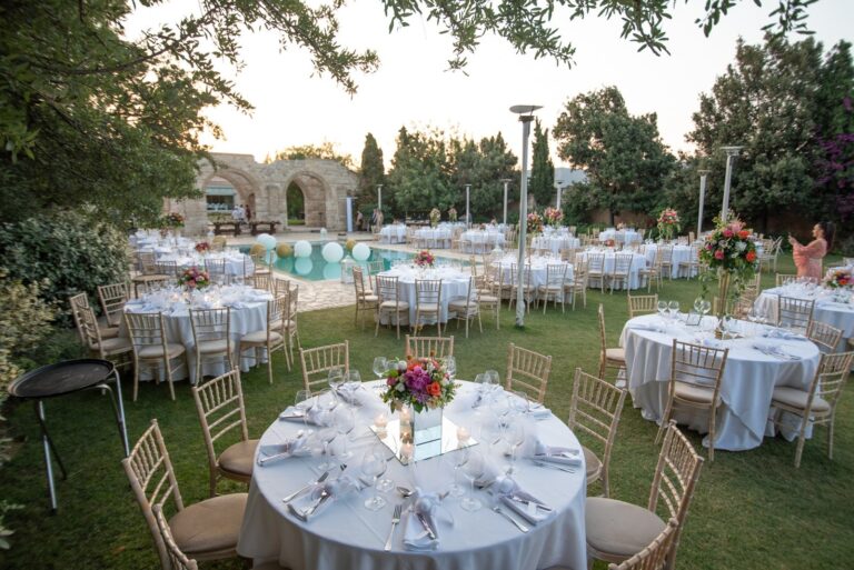 Round tables set beside a pool in a garden, Mathioudakis Exclusive Events