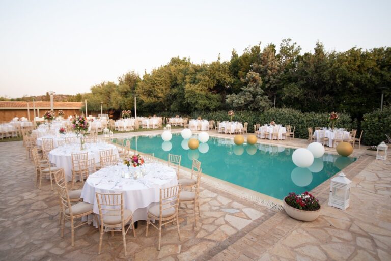 Dinner tables arranged around a pool at dusk, Mathioudakis Exclusive Events