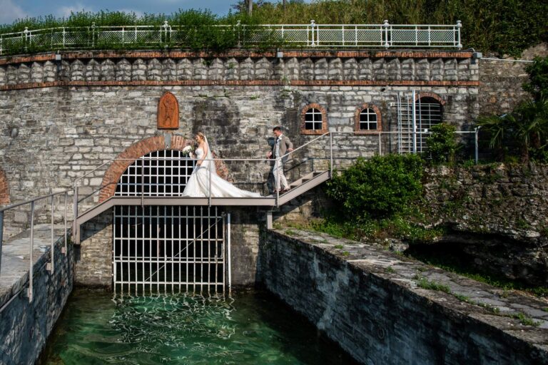 Bride and groom on the stone bridge above the old water gate at Villa Lario Resort, Lake Como, Matteo Cuzzola Photography