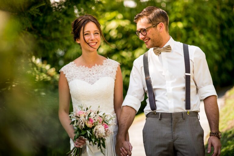 Bride and groom walking hand in hand through a garden at a Lake Maggiore wedding, Matteo Cuzzola Photography