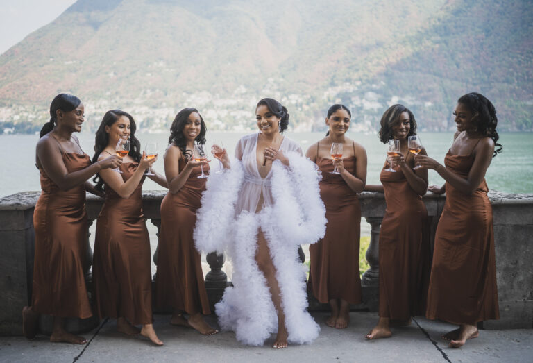 A bride and her bridesmaids raising a glass on the lakeside terrace, from his Villa Erba page, Matteo Cuzzola Photography