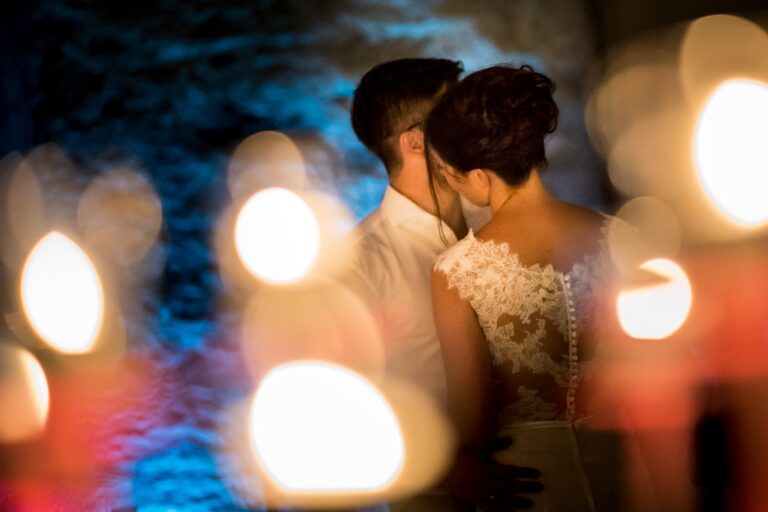 Bride and groom close together behind candlelight at a Lake Maggiore wedding, Matteo Cuzzola Photography
