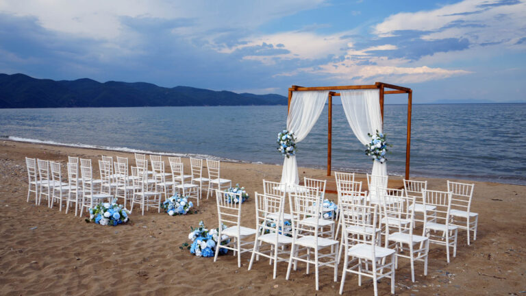 Beach ceremony aisle and arch beside the sea at dusk, Mazal Weddings