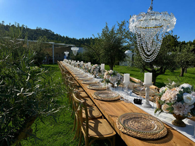 Long table with a crystal chandelier among the olive trees, Mazal Weddings