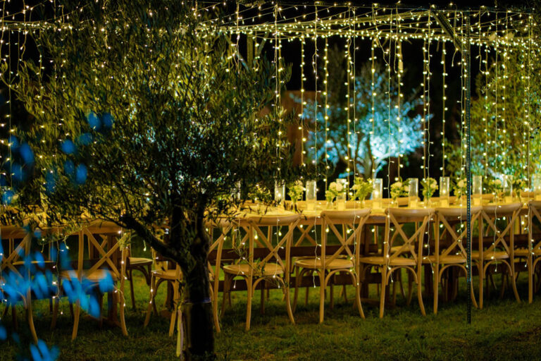 Reception tables under a canopy of lights, Mazal Weddings
