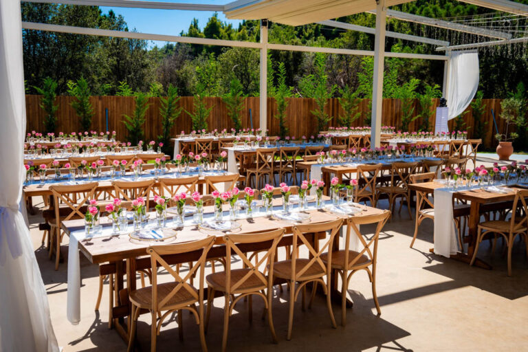 Reception tables set with flowers on the terrace, Mazal Weddings