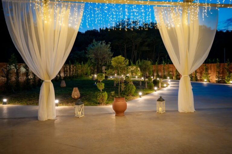 White drapes and lights over a terrace at dusk, Mazal Weddings