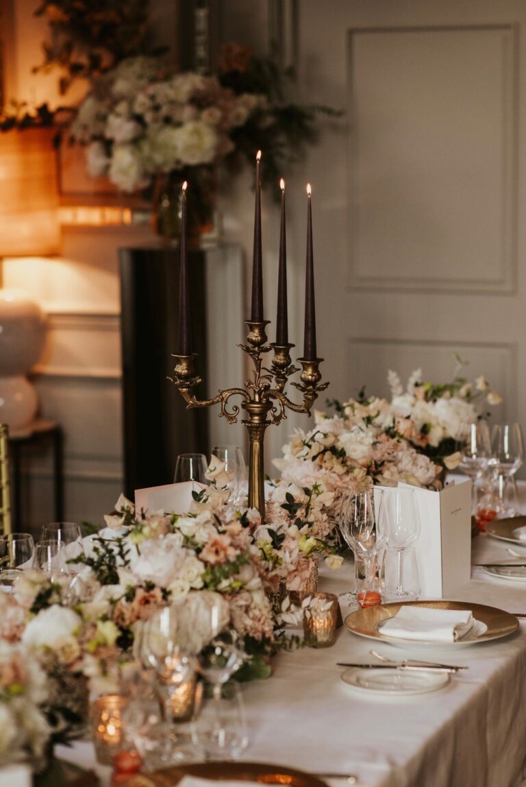 A candlelit reception table dressed in black candelabra and blush florals, an intimate London city wedding, McQueens Flowers