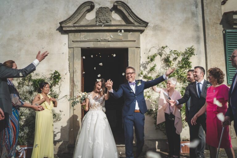 Petals thrown as the couple leave the Church of Argiano in San Casciano in Val di Pesa, Michele Monasta Photography