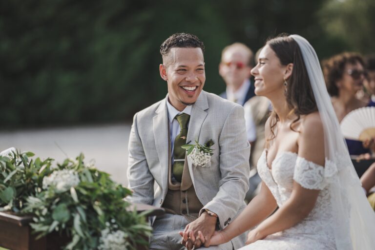 Bride and groom laughing hand in hand during their outdoor ceremony at Villa il Gran Duca, Michele Monasta Photography