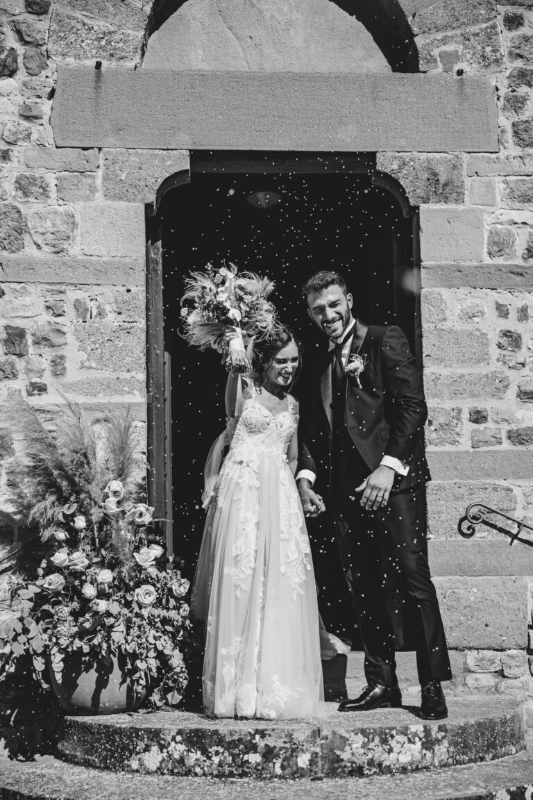Rice falls as the couple step out of the Pieve di Borgo San Lorenzo in the Mugello, Michele Monasta Photography