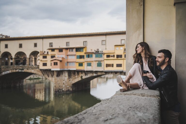 A couple shoot before the wedding beside the Arno, looking across to the Ponte Vecchio in Florence, Michele Monasta Photography