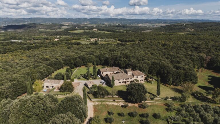 Borgo Gallinaio from the air, set among woods and cypresses in the hills near Siena, Michele Monasta Photography