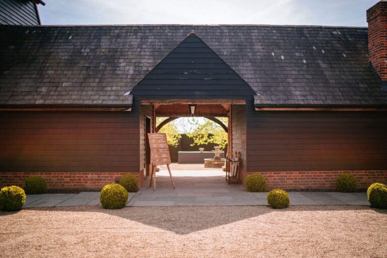 The Great Barn cart-lodge archway onto the gravel courtyard, Micklefield Hall