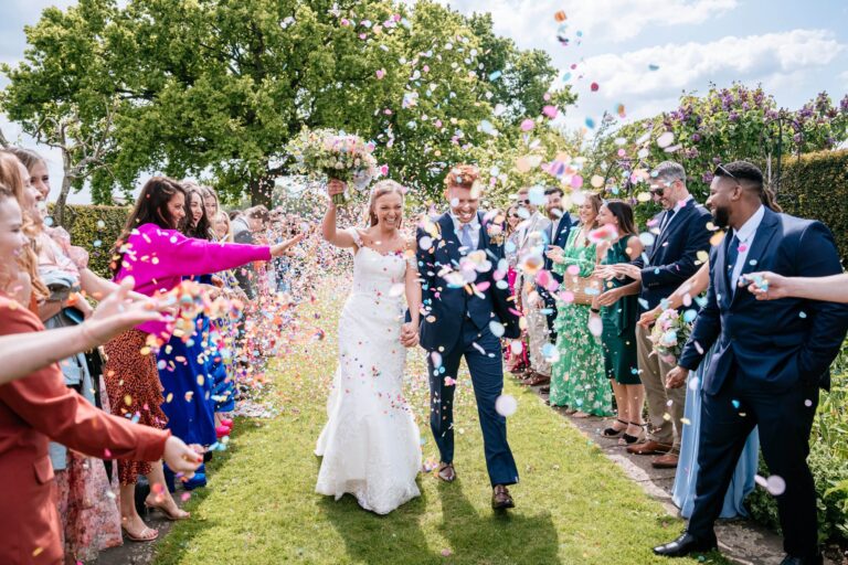 Confetti as the couple leave the outdoor ceremony, Micklefield Hall