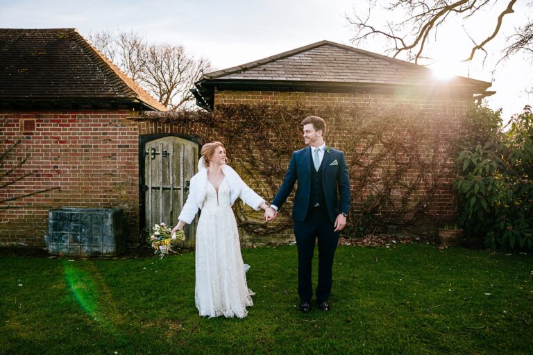 The couple by the garden wall in low evening sun, Micklefield Hall