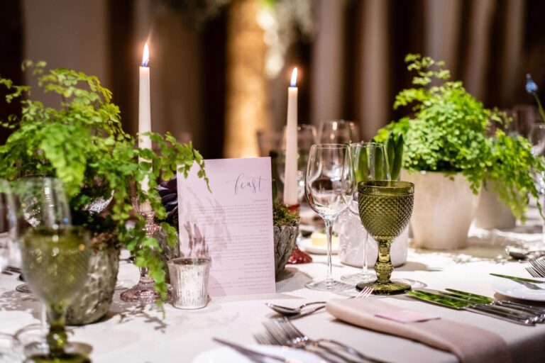 A table setting of candles and greenery, Micklefield Hall