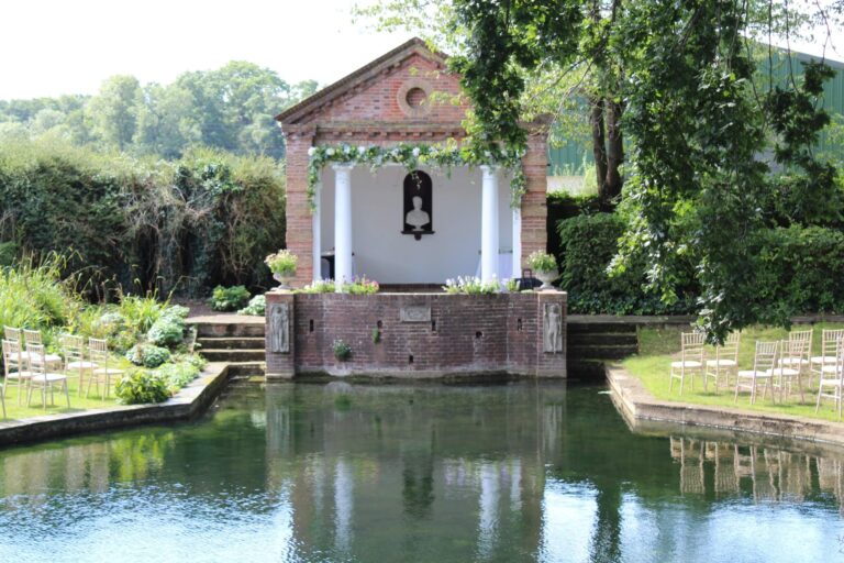 The Temple dressed with a floral garland, seen across the pond, Micklefield Hall