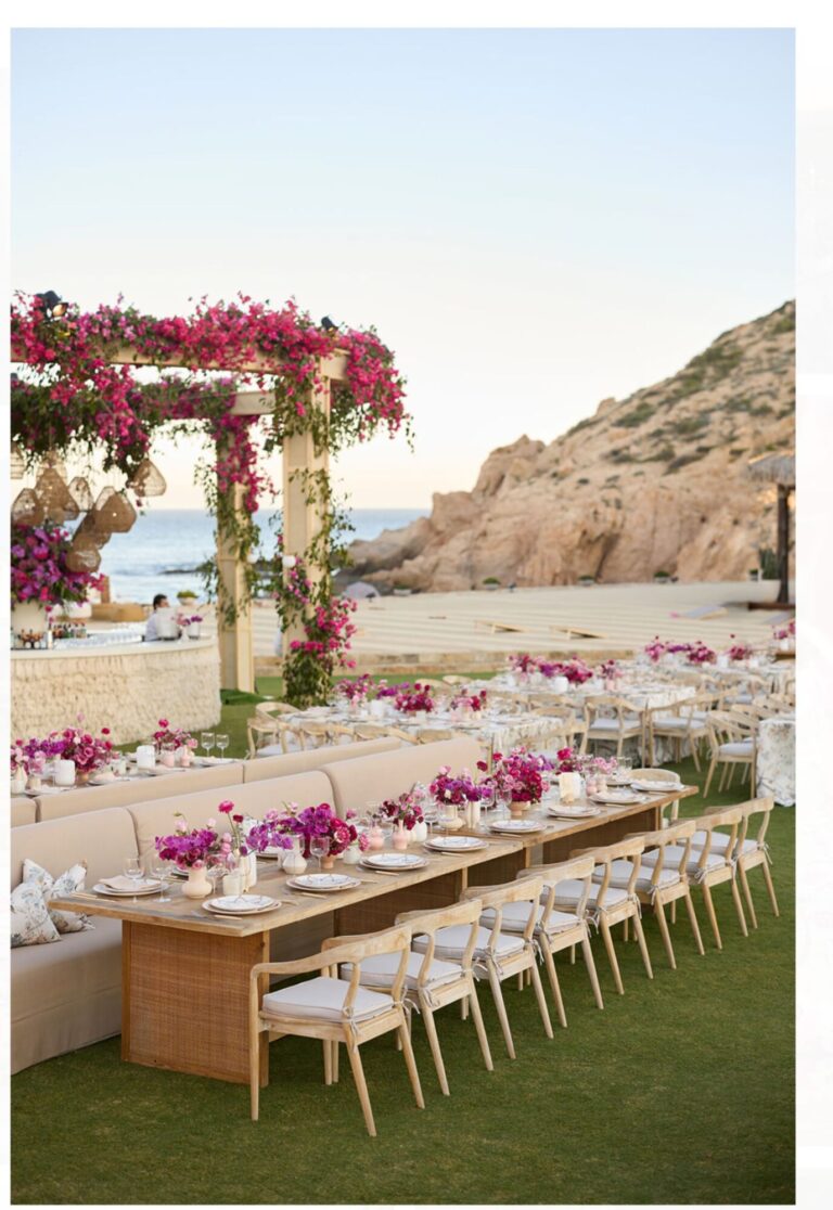 A long table and bougainvillea pergola above a rocky beach, Mindy Weiss Party Consultants