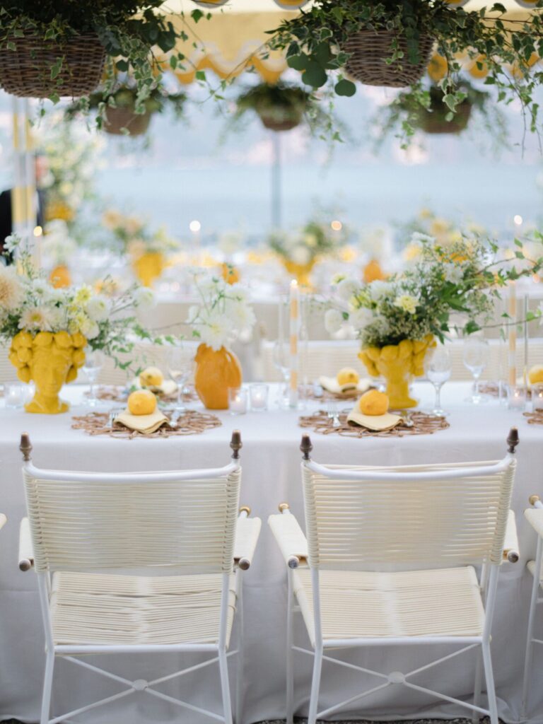 Tables dressed in yellow vases and lemons beneath a hanging-flower canopy, Mindy Weiss Party Consultants