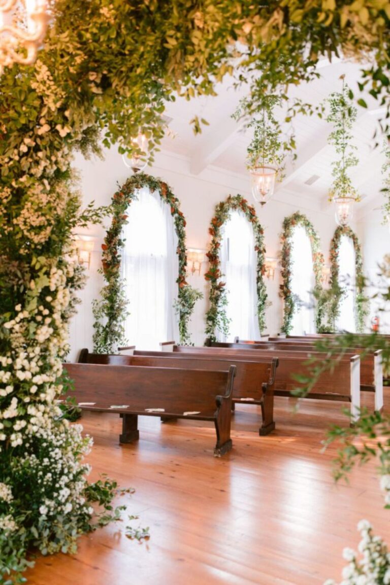 A chapel interior with flowered arches and wooden pews, Mindy Weiss Party Consultants