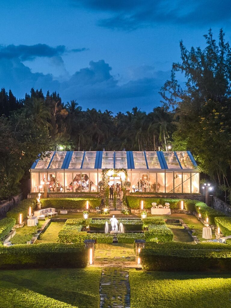 A lit marquee and formal garden at night, Mindy Weiss Party Consultants
