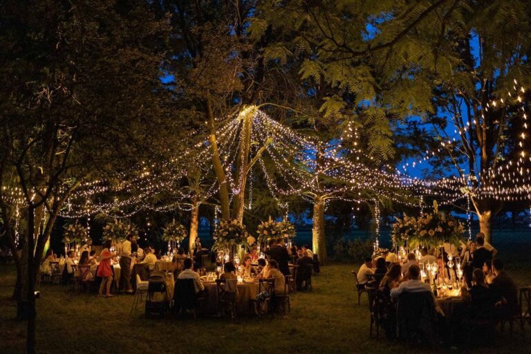 Fairy lights strung between the trees over the dinner at dusk, Mirko Zago, Sparkling Weddings and Events