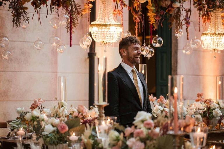 Candlelit tables against the villa wall, chandeliers and glass baubles hung above, Mirko Zago, Sparkling Weddings and Events