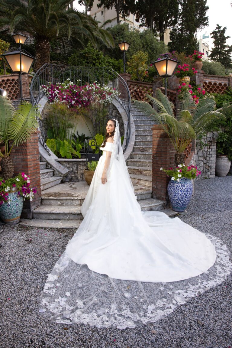 A bride on a garden staircase in Taormina, Sicily, Mitheo Events
