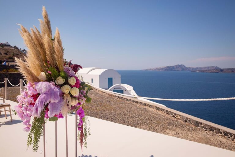 A tall floral arrangement on a terrace above the sea in Santorini, Mitheo Events