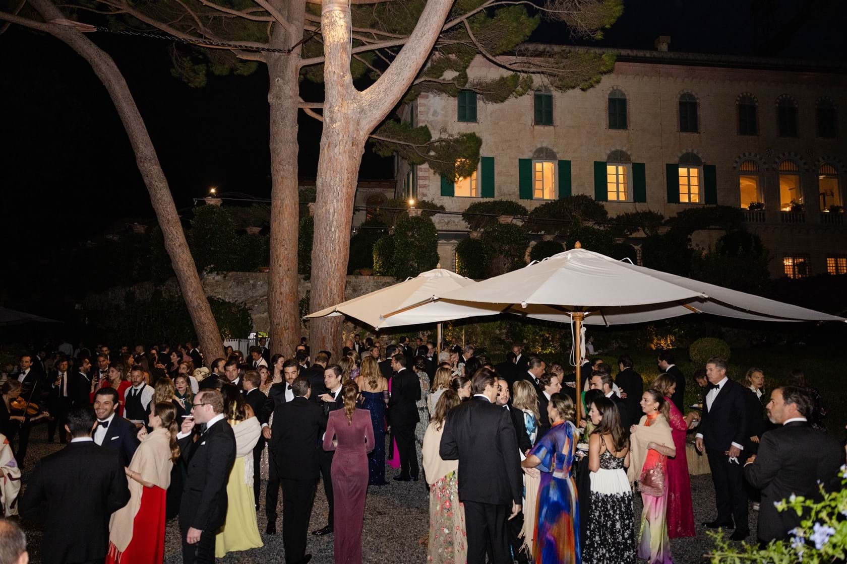 Guests gather for an evening garden reception in Portofino, Mitheo Events