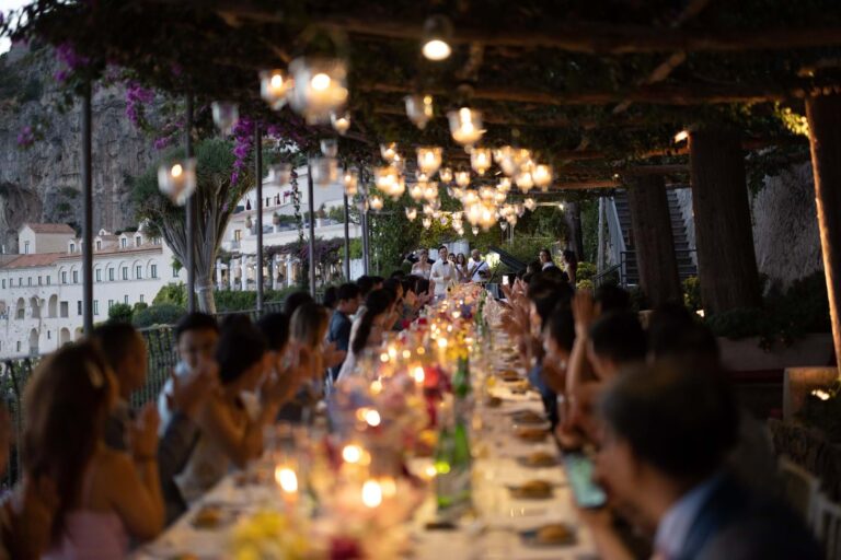 Candlelit long table dinner under a vine pergola on the Amalfi Coast, Mitheo Events