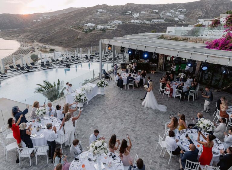 Wedding reception tables beside the pool and sea in Mykonos, Mitheo Events